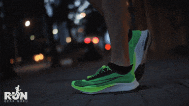 A man Tight the laces of Nike Zoom fly 3 and standing in  Nike Vaporfly next 