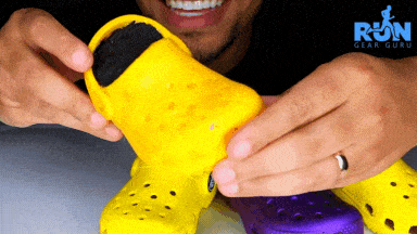 A man eating yellow crocs